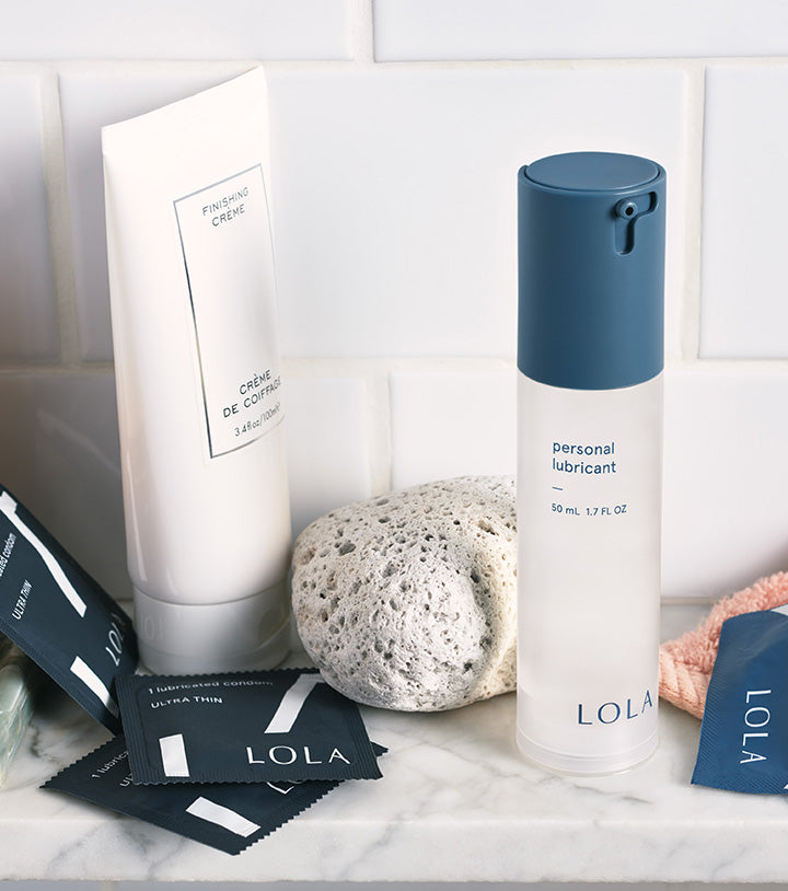 Personal lubricant, Ultra thin condoms | Close up, front view of the personal lubricant and condoms on a bathroom counter