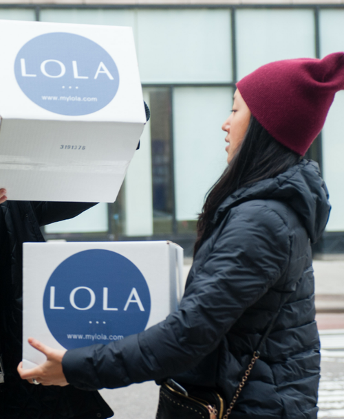 Side view of a LOLA volunteer donating LOLA products for I Support the Girls