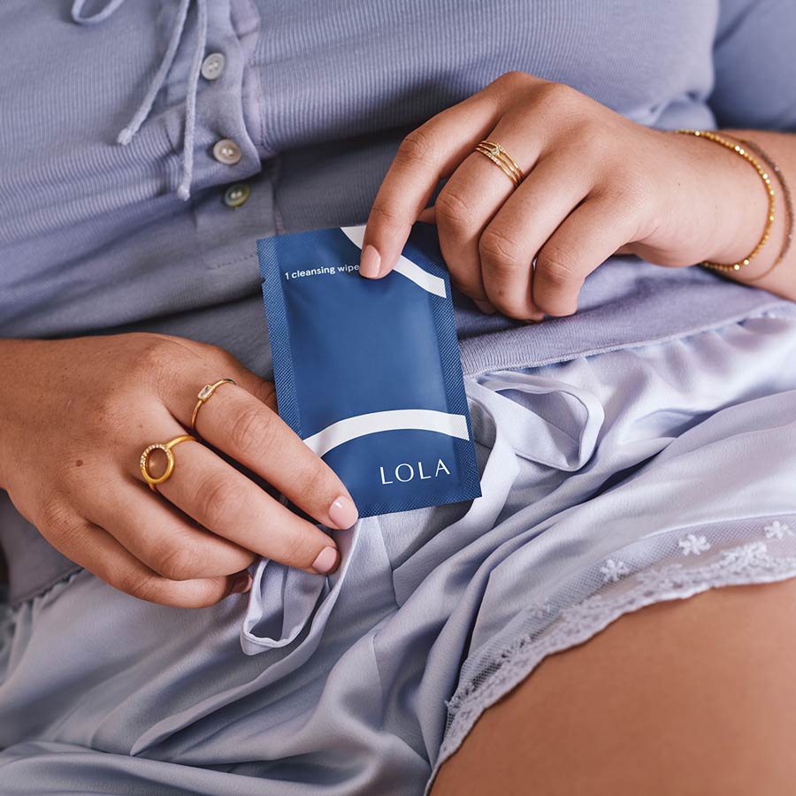 Person holding a Lola cleansing wipes packet